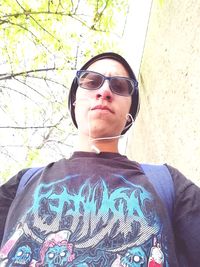 Portrait of man wearing sunglasses standing outdoors