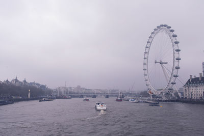 Ferris wheel in city against sky