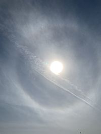 Low angle view of sun shining in sky