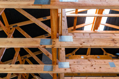 Roof trusses covered with a membrane on a detached house under construction, visible roof elements