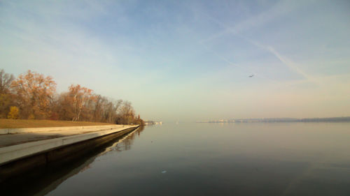 Scenic view of river against sky at sunset