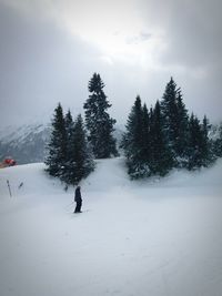 Man on snow covered landscape against sky