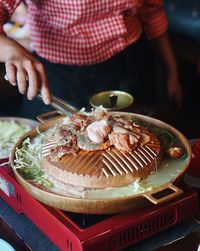 Close-up of person preparing food on table