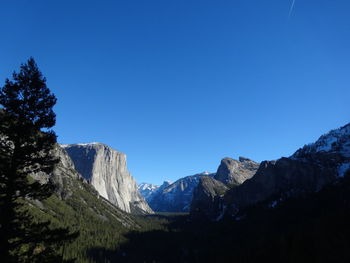 Scenic view of mountains against clear blue sky