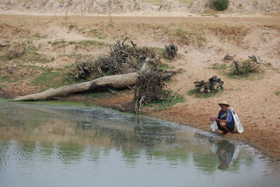 Reflection of man on water in lake