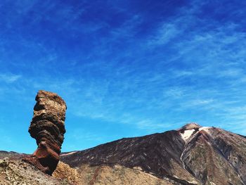 Low angle view of rock formation against sky