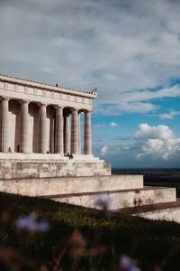 Low angle view of historical building against cloudy sky