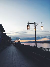 Street light on road against sky during sunset