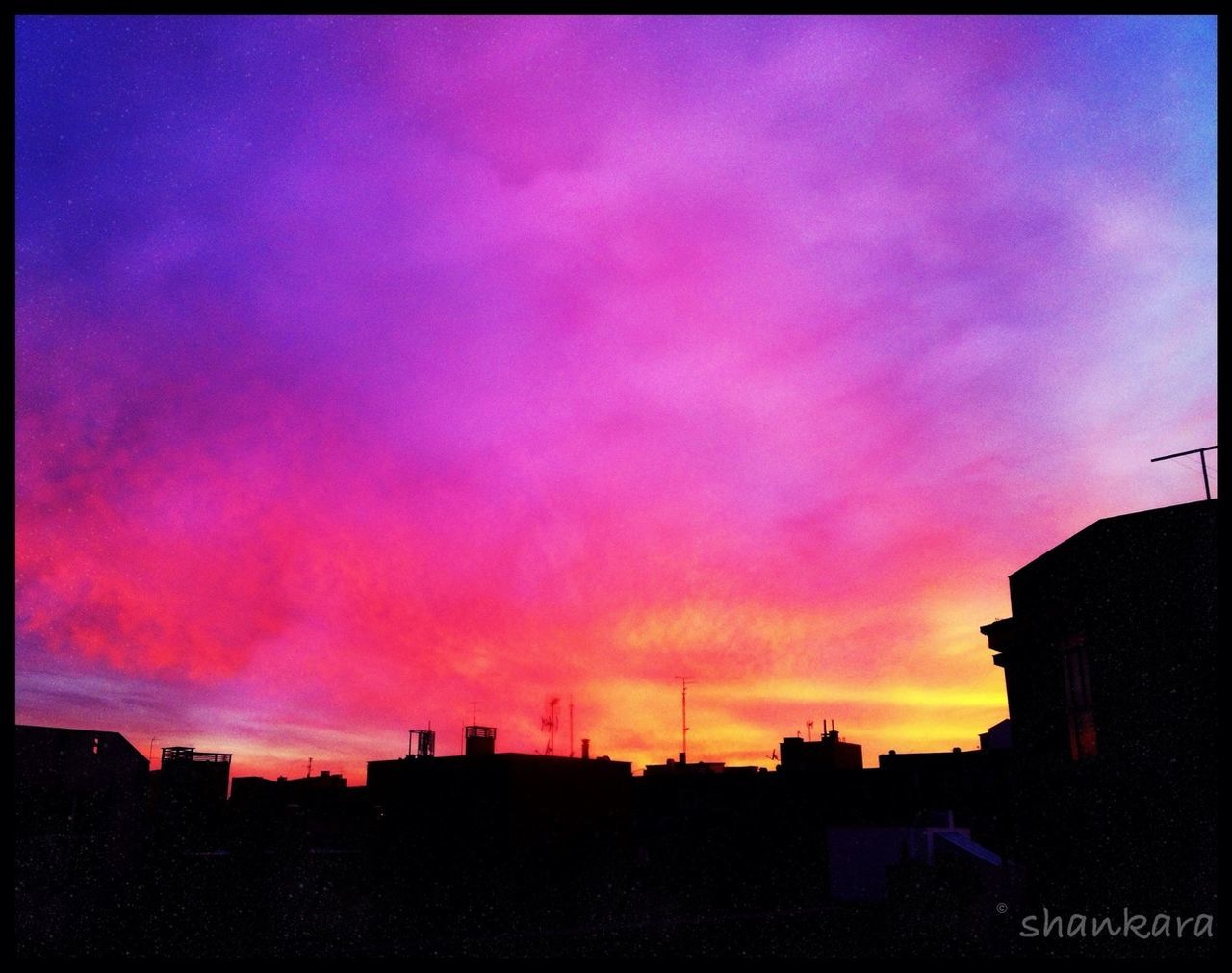 building exterior, sunset, silhouette, architecture, built structure, sky, cloud - sky, orange color, city, dusk, auto post production filter, dramatic sky, low angle view, transfer print, beauty in nature, cloud, residential structure, outdoors, building, scenics