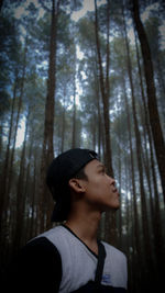 Low angle view of young man in forest