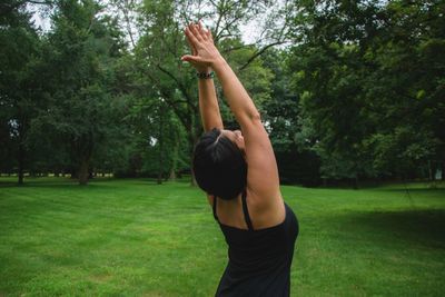 Mid adult woman practicing yoga at public park