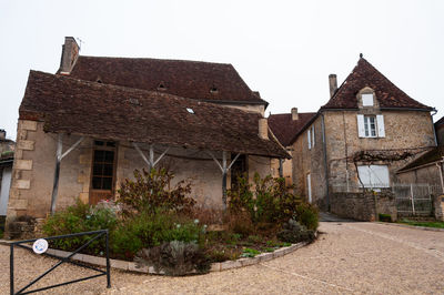 Exterior of old building in town against clear sky