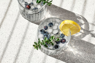 Fresh summer drink blueberry mojito or blueberry icy lemonade with lemon, blueberries,ice and thyme.