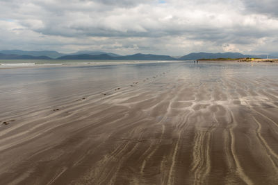 View of beach against cloudy sky