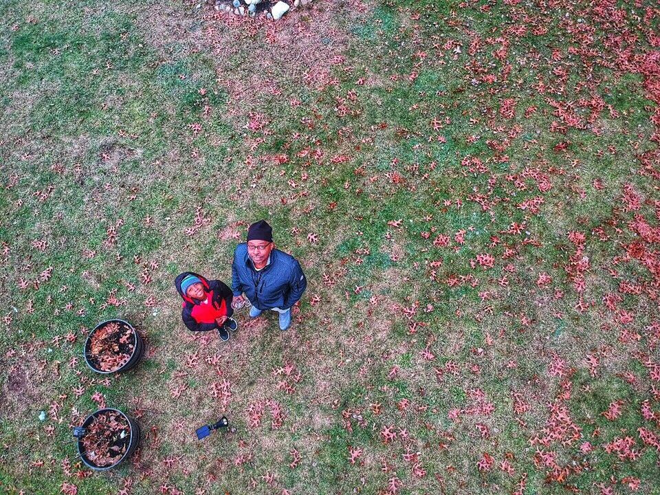 one person, high angle view, plant, real people, men, casual clothing, land, field, day, full length, growth, leisure activity, lifestyles, nature, flower, grass, flowering plant, males, front view, outdoors