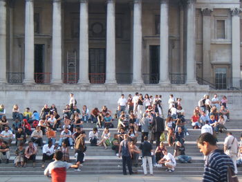 People walking on street against buildings in city