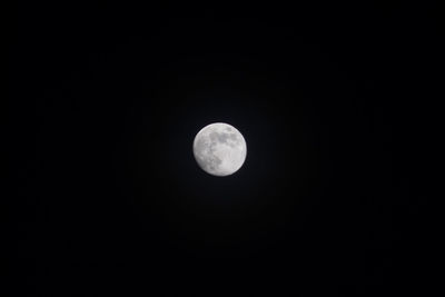 Low angle view of moon against dark sky