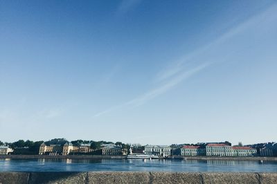 Scenic view of river against clear blue sky