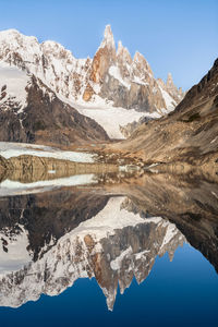 Scenic view of lake and snowcapped mountains against sky