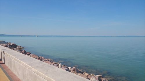 Scenic view of sea against blue sky