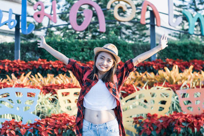 Portrait of a smiling young woman standing outdoors