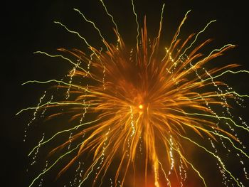 Low angle view of firework display at night