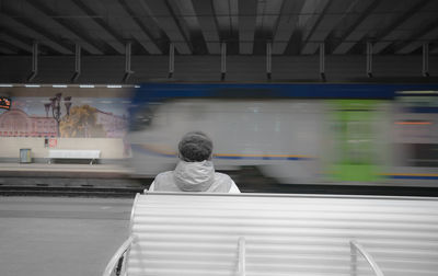 Rear view of people on railroad station platform