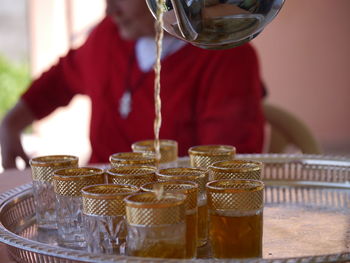 Midsection of man pouring wine in glass