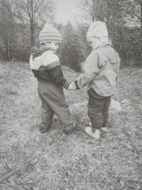 Two children standing on field