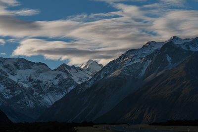 Scenic view of snowcapped mountain against cloudy sky