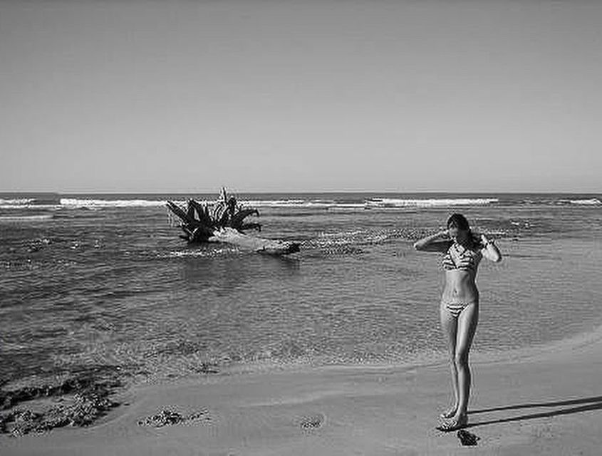 WOMAN STANDING ON SHORE