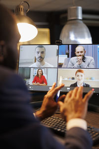 Midsection of woman using laptop at office