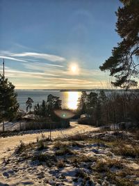 Scenic view of frozen lake against sky during sunset