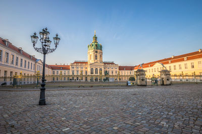 Buildings in town against blue sky