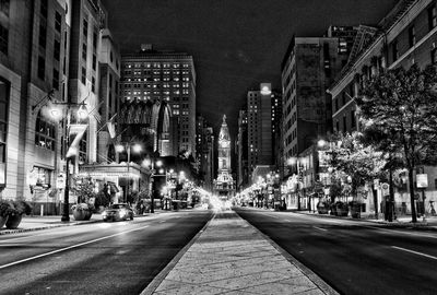 Illuminated city street at night