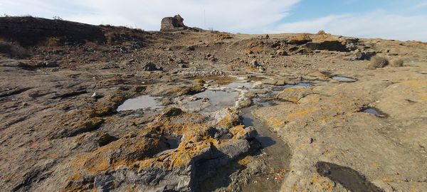 Rock formations on landscape against sky