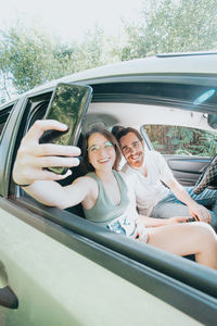 Low section of woman sitting in car