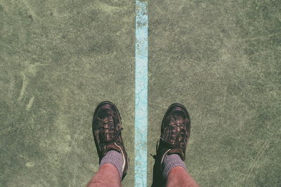 Low section of person standing on tiled floor