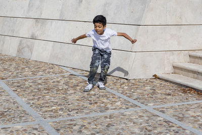 Young boy jumping while having fun in a park.