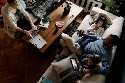 High angle view of people sitting on sofa