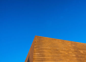 Low angle view of building against clear blue sky