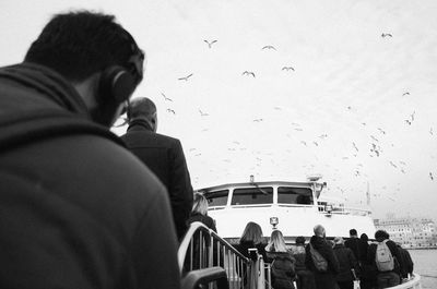 Rear view of man and woman flying bird