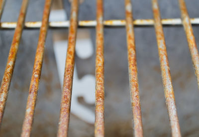 Full frame shot of rusty metal grate over footpath