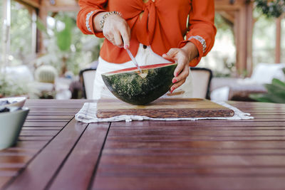 Midsection of woman holding ice cream