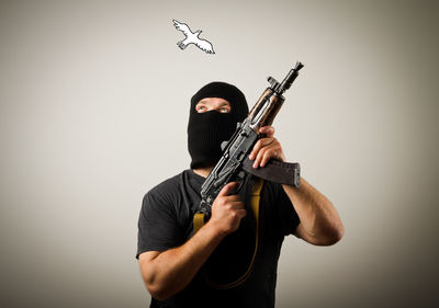 Full length of man wearing mask against white background