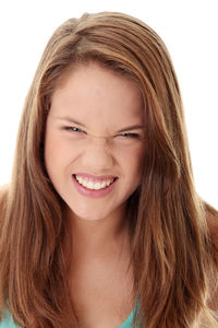 Close-up portrait of a smiling young woman over white background