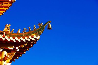 Low angle view of built structure against clear blue sky