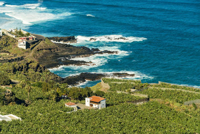 Farm village by the coast of tenerife with blue sea water