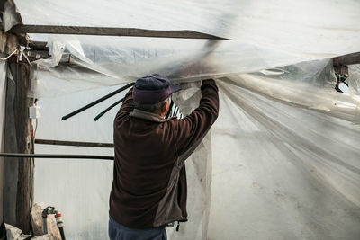 Rear view of man working