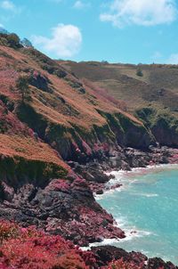 Scenic view of sea and mountains against sky